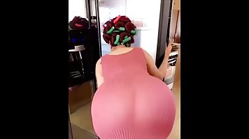 Voluptuous woman in sheer dress is showing her ass to the camera, just for fun