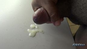 check out how this black cock bust a huge and creamy nut on a table