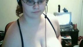 Nerdy busty brunette finger fucks her moist punani