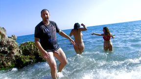 Busty girl in threesome on the beach