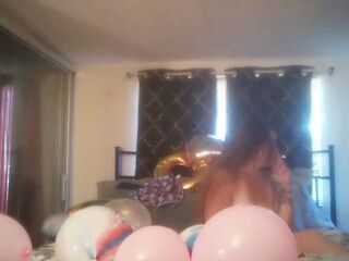 Incredibly excited gal takes off her costume and smokes cigarettes and pops balloons in nature's garb