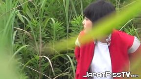 Slutty Japanese girl rubs her hairy pussy while peeing outdoor
