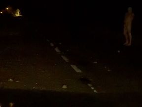 Naked in road and hiding the wrong side of road from safety when car passed