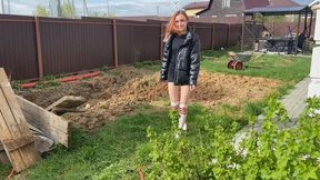 A girl in white stockings walks through the mud, gets stuck to her and gets her legs and white stockings sucked inside