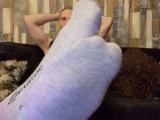 Showing feet in grey socks while playing with cock