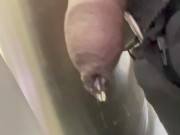 Drip hangs from uncut black dick while at work.
