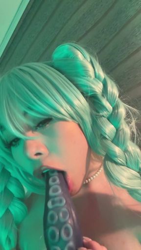 Blonde haired woman with braids holding a dildo