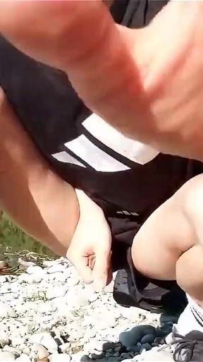 Jon Arteen Wanks Outdoor on a Pebbles Beach, the Sexy Twink Wearing Short Shorts Cums on His Thigh and Cumplay