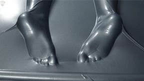 Tickling and flogging feet in a gray latex bed
