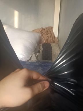 Close-up of hand holding black trash bag