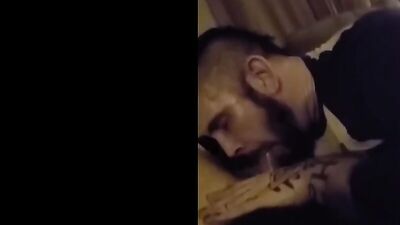 Inked bearded guy is filmed while passionately sucking a dick