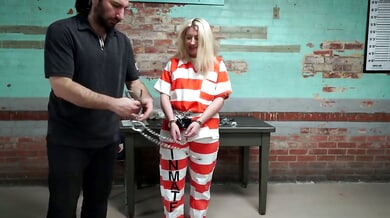 Constance trapped in a striped prison uniform and locked in a cage