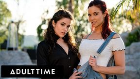 Jayden Cole and Victoria Voxxx pose outdoors in black shirt and denim overalls before lesbian bedroom play