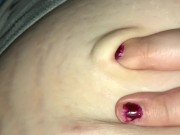 Woman moaning and playing with soft bellybutton
