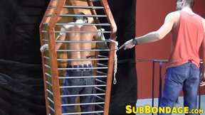 BDSM fun with a dude trapped in a cage by his master