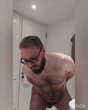 Chastity locked bear plays with his new tail toy