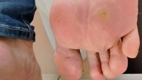Public Restroom Sock Removal – Bare Soles Close Up After Taking Off Shoes