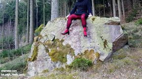 In the forest with high heels and red pants