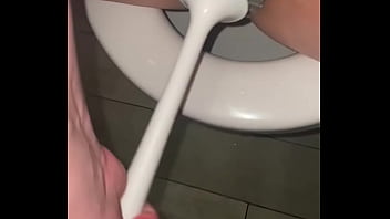 Filthy slut licks public toilet in the hotel and plays with toilet brush