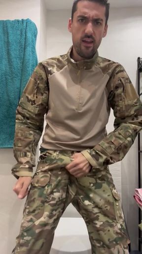 Military guy two hands jerks his meat