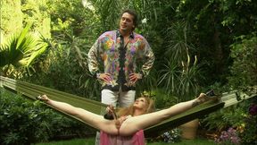 annie body is enjoying a relaxing summer day in her hammock when a colorful man approaches her
