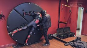 Pup twink dressed as Spider-Man strapped to the bondage wheel and milked