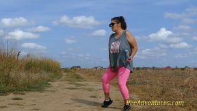 Fat brunette with sunglasses pee in her tights on a dirt road