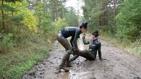 Two leather-clad hotties wrestling in the mud