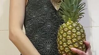 skinny girl playing with pineapple