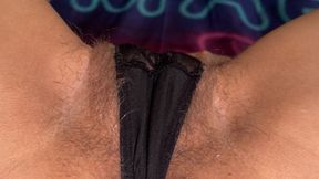 An extremely close-up shot of a hairy pussy.