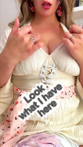 An elegant MILF carefully sits down on a huge cushion with her bum.