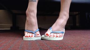 Pretty red toenails in flip flops