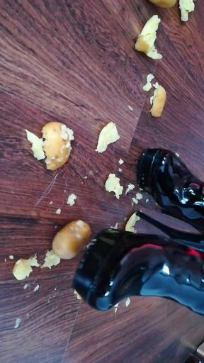 The lady in beautiful boots crushes potatoes
