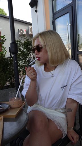 Woman smoking in outdoor cafe