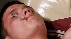 Teen gay Denis lights up cigar and tugs rod with hand