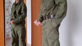 A Russian soldier in military uniform and dirty socks jerks off his dick