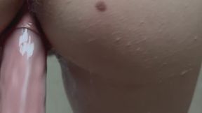 Close up dildo fuck from behind in the shower