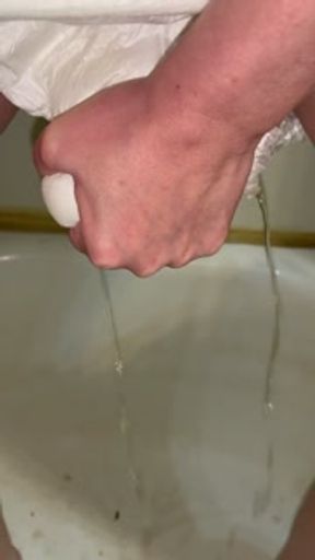 Squeezing the pee out of my diaper so I can wear it again