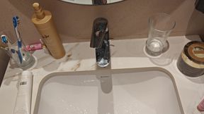 Young man pissing in the sink