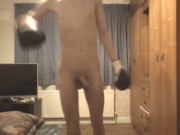 Skinny twink in boxing gloves does shadow boxing and shows off his ribs