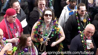 MILF flashes her large breasts during Mardi Gras street celebration
