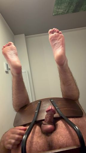feet hanging from chair