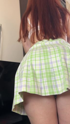 Curvy redhead in plaid skirt