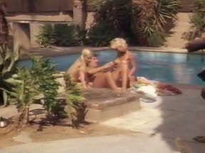 Two hot blondes are having fun with this moustached dude by the pool