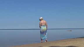 my wife is on the beach in a yellow bikini
