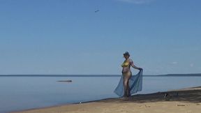 my wife is on the beach in a yellow bikini