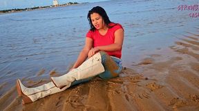 Wetlook in jeans and white boots and hair flipping in the sea