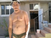 Handsome man showing off hot body in yard