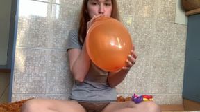 Naughty girl popping ballons