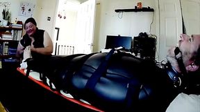 Miss K tickle torments a mans feet whilst bound in neoprene bondage sack